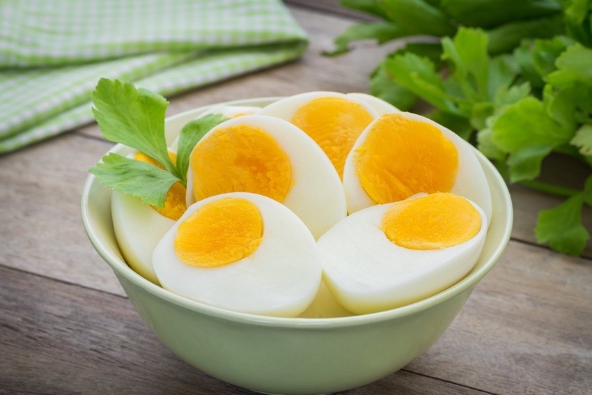 Hard-boiled eggs sliced in half in a bowl