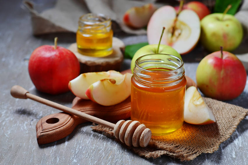 Jar of honey with sliced apples for rosh hashana